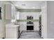 Bright kitchen features white cabinets, stainless steel appliances and modern countertops at 5513 Nickel Ridge Way, Las Vegas, NV 89122