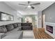 Bright living area with a modern fireplace, ceiling fan, and a comfortable sectional sofa at 5513 Nickel Ridge Way, Las Vegas, NV 89122