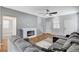 Comfortable living room with a modern fireplace, wood floors, and a large sectional sofa at 5513 Nickel Ridge Way, Las Vegas, NV 89122