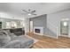 Cozy living room with a modern fireplace, ceiling fan, and hardwood floors at 5513 Nickel Ridge Way, Las Vegas, NV 89122
