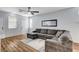 Spacious living room featuring a large sectional sofa, wood floors, and neutral paint colors at 5513 Nickel Ridge Way, Las Vegas, NV 89122