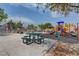Neighborhood playground with picnic tables, a barbecue, and a playground in a park-like setting at 5513 Nickel Ridge Way, Las Vegas, NV 89122