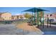 Community playground with shade covering, benches, and tables, perfect for outdoor fun at 5513 Nickel Ridge Way, Las Vegas, NV 89122