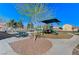 Charming community playground area featuring picnic tables, playground equipment, and shade at 5513 Nickel Ridge Way, Las Vegas, NV 89122