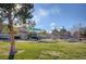 Beautiful community playground featuring a slide, picnic tables, and mature trees at 5513 Nickel Ridge Way, Las Vegas, NV 89122