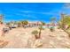 Large backyard shows desert landscaping, in-ground pool, patio, furniture and exterior elevation at 5527 Breecher Ave, Las Vegas, NV 89131