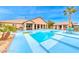 Spacious backyard features an in-ground pool and desert landscaping and colorful patio sets at 5527 Breecher Ave, Las Vegas, NV 89131