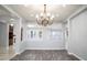 Dining room featuring a modern chandelier, wood floors, and bright natural light at 5527 Breecher Ave, Las Vegas, NV 89131