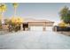 Spacious home with a three-car garage, desert landscaping, and neutral stucco exterior at 5527 Breecher Ave, Las Vegas, NV 89131