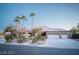Beautiful single-story home with three-car garage, lush landscaping, and a circular driveway at 5527 Breecher Ave, Las Vegas, NV 89131
