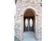 Close up of the front door showcasing the arched stone turret and oval glass windows at 5527 Breecher Ave, Las Vegas, NV 89131