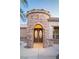Close up of the front entrance featuring a stone turret and decorative glass double doors at 5527 Breecher Ave, Las Vegas, NV 89131