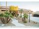 Beautiful home with a walkway, mature palm trees, and a three car garage at 5527 Breecher Ave, Las Vegas, NV 89131