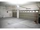 Large, empty three-car garage featuring paneled doors and ample storage space at 5527 Breecher Ave, Las Vegas, NV 89131