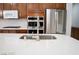 Kitchen island with white countertops and stainless steel appliances at 5527 Breecher Ave, Las Vegas, NV 89131