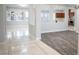 Open-concept living space with marble and wood floors, stylish columns, and bright natural light at 5527 Breecher Ave, Las Vegas, NV 89131