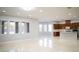 Open-concept living area with large windows and stylish kitchen view at 5527 Breecher Ave, Las Vegas, NV 89131