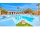 Bright blue pool and jacuzzi with a pool house surrounded by palm trees on a sunny day at 5527 Breecher Ave, Las Vegas, NV 89131