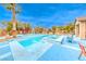 Backyard features an in-ground pool and spa, desert landscaping and colorful patio sets at 5527 Breecher Ave, Las Vegas, NV 89131