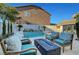Inviting backyard with a fire pit, ample seating, and a tranquil pool at 5712 Almocita Ct, Las Vegas, NV 89141