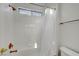 Bright bathroom featuring tiled walls, bronze fixtures, and a window over the bathtub at 5712 Almocita Ct, Las Vegas, NV 89141