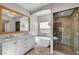 Luxurious bathroom with double vanity, standalone tub, and glass-enclosed shower at 5712 Almocita Ct, Las Vegas, NV 89141