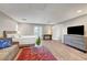 Spacious bedroom with seating area, light wood floors, and access to an outdoor balcony at 5712 Almocita Ct, Las Vegas, NV 89141