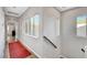 Hallway featuring wood floors, a red rug, and multiple windows offering natural light at 5712 Almocita Ct, Las Vegas, NV 89141