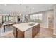 Open kitchen with island, stainless steel appliances, and seamless flow to the living area at 5712 Almocita Ct, Las Vegas, NV 89141