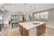 Open concept kitchen with an island, stainless steel appliances, and adjacent dining and living areas at 5712 Almocita Ct, Las Vegas, NV 89141