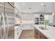Modern kitchen with white cabinets, stainless steel appliances, and a marble countertop at 5712 Almocita Ct, Las Vegas, NV 89141