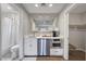 Cozy kitchenette featuring white cabinets, a sink, built-in microwave, and a coffee maker at 5712 Almocita Ct, Las Vegas, NV 89141