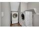 Convenient laundry room with a stacked washer and dryer and built-in shelving at 5712 Almocita Ct, Las Vegas, NV 89141