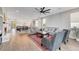 Spacious living room with wood floors, grey couches, and a view of the kitchen and dining area at 5712 Almocita Ct, Las Vegas, NV 89141