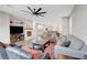 Open concept living room with fireplace, grey couches, wood floors, and access to the kitchen and dining area at 5712 Almocita Ct, Las Vegas, NV 89141