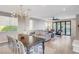 Open concept living room with large glass doors to the outside and stylish decor at 5712 Almocita Ct, Las Vegas, NV 89141
