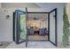Open concept living room featuring hardwood floors, fireplace, and bi-fold glass doors at 5712 Almocita Ct, Las Vegas, NV 89141