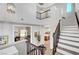 Open staircase with a railing and a view of the kitchen and dining area, enhancing the home's openness at 5712 Almocita Ct, Las Vegas, NV 89141