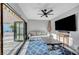 Enclosed sun room with bi-fold doors, seating, tv, and blue patterned rug at 5712 Almocita Ct, Las Vegas, NV 89141