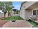 Backyard featuring a basketball hoop, artificial grass, and a seating area at 5954 Rose Sage St, North Las Vegas, NV 89031