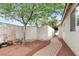 Backyard space featuring brick, rock landscaping, and a tree at 5954 Rose Sage St, North Las Vegas, NV 89031