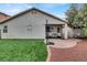 Backyard with artificial grass, stone landscaping, basketball hoop, and covered patio at 5954 Rose Sage St, North Las Vegas, NV 89031