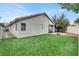 Backyard featuring artificial grass, a basketball hoop, and a covered patio at 5954 Rose Sage St, North Las Vegas, NV 89031