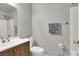 Bathroom featuring a wood vanity, toilet, shower, and towel rack at 5954 Rose Sage St, North Las Vegas, NV 89031