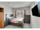 Bedroom features gray walls, carpet floors, closet, and a large window for natural light at 5954 Rose Sage St, North Las Vegas, NV 89031