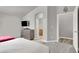 Spacious bedroom with carpet features a TV, closet, and ensuite bathroom entrance at 5954 Rose Sage St, North Las Vegas, NV 89031