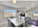 Bright dining area with a modern glass table, comfortable seating, and plenty of natural light at 5954 Rose Sage St, North Las Vegas, NV 89031