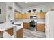 Functional kitchen with ample counter space, modern appliances, and plenty of storage in the light wood cabinets at 5954 Rose Sage St, North Las Vegas, NV 89031