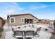 Backyard patio with rock landscape, pavers, and outdoor dining set for a relaxing outdoor setting at 6261 Lamont Hills Ave, Las Vegas, NV 89139
