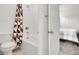 Bathroom with white tile and shower with geometric shower curtain at 6261 Lamont Hills Ave, Las Vegas, NV 89139